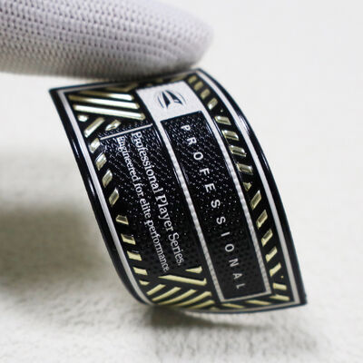 แพทช์ความถี่สูง TPU ที่กําหนดเอง - เหรียญทองโลหะและสีดํา แบจเกมมืออาชีพสําหรับชุดกีฬา